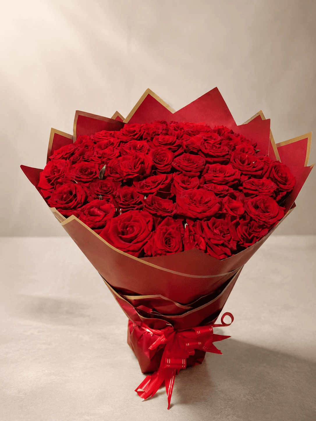 Large red rose bouquet in red and gold wrapping, flower delivery Meknes