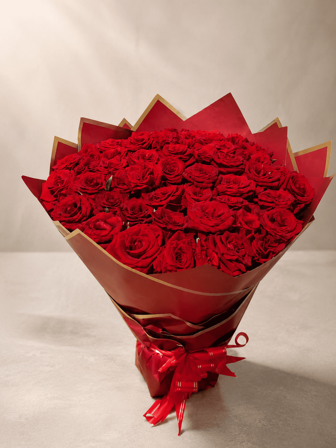 Large red rose bouquet in red and gold wrapping, flower delivery Meknes